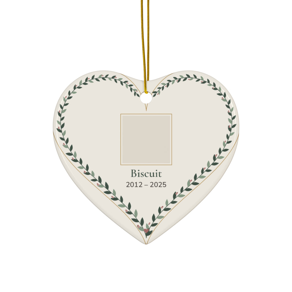 Heart-shaped ceramic pet memorial ornament with a personalized pet photo, name and dates inside a leafy vine border